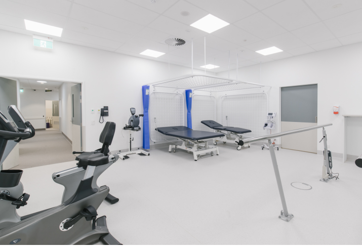 Interior view of outpatients facility with exercise bike and beds  