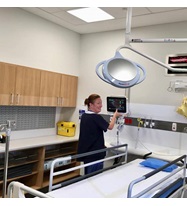 Clinician adjusting a hospital room.