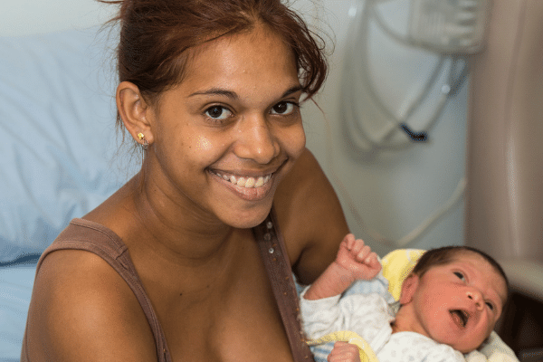 Aboriginal mother smiling with newborn
