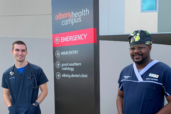 Two members of staff outside Albany Health Campus