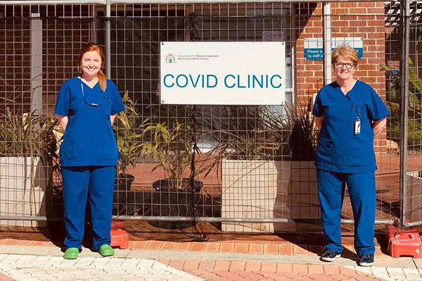 COVID clinic staff members with sign