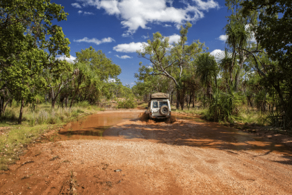 Four wheel drive crosses small creek in the North West