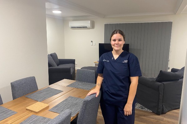 Staff member in front of dining table in staff accommodation