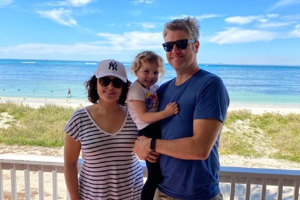 Dr Kate Poland at beach with husband and young daughter