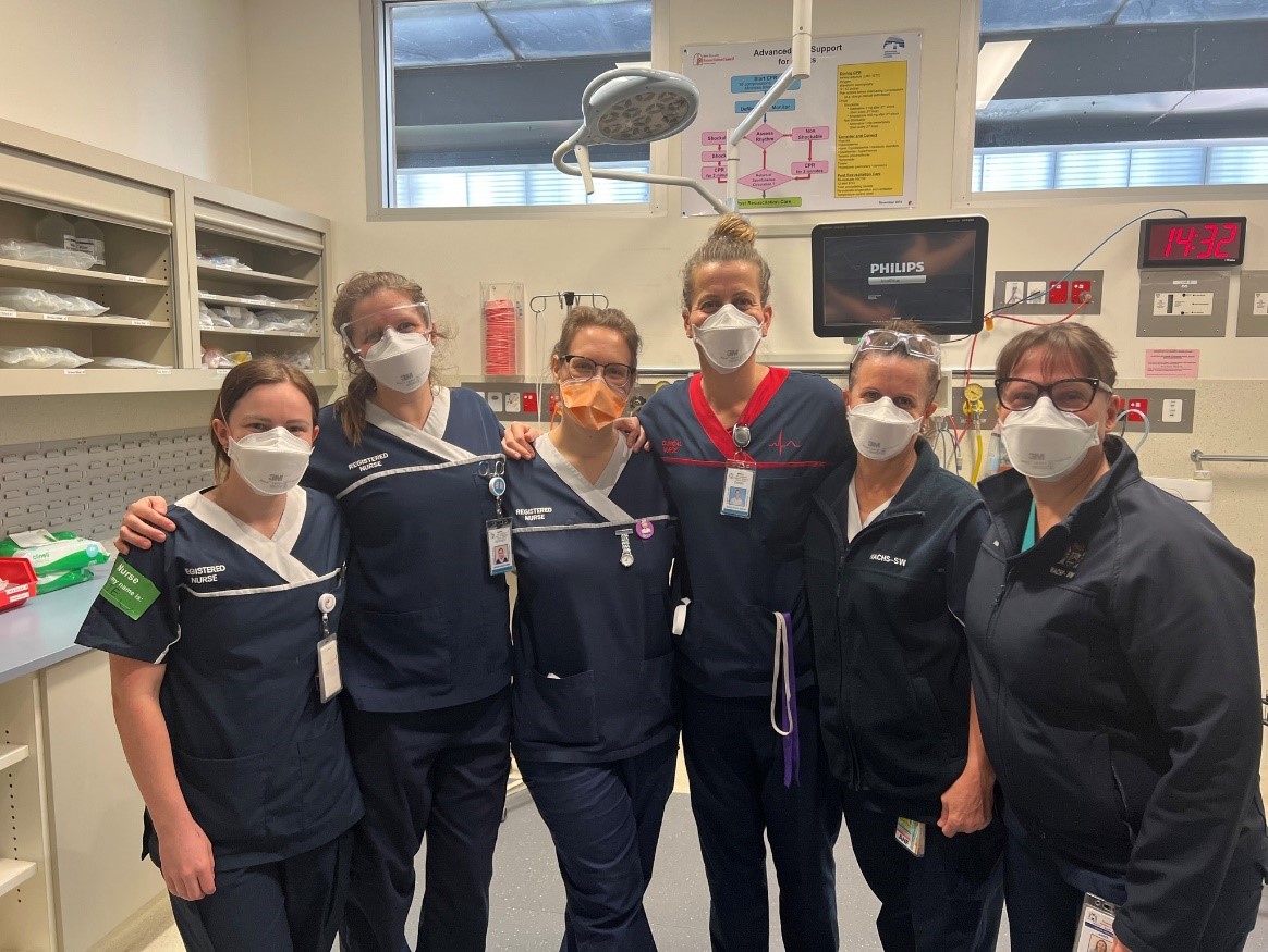 Six Bunbury Hospital clinicians wearing masks gathered in a treatment room