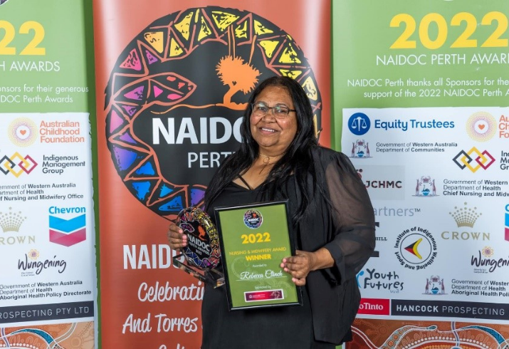 Rebecca Clinch smiling, holding her NAIDOC Perth 2022 Nursing and Midwifery Award