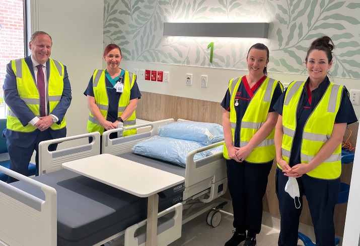 Staff at bedside in high vis 