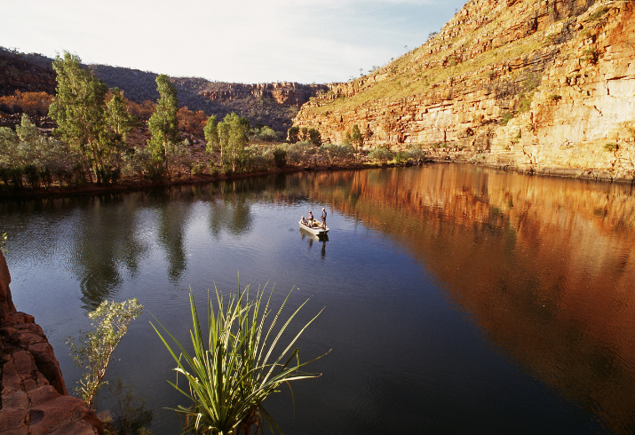 Boat on a river surrounded by a Kimberley gorge