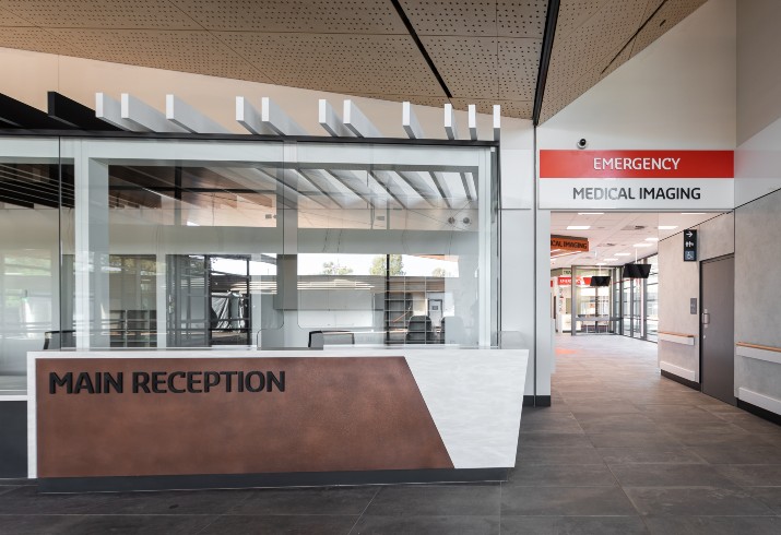 Main reception desk at Newman Hospital and sign pointing to medical imaging facilty. 