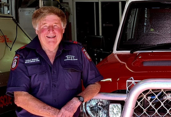 Gyula Bogar standing next to a fire truck.