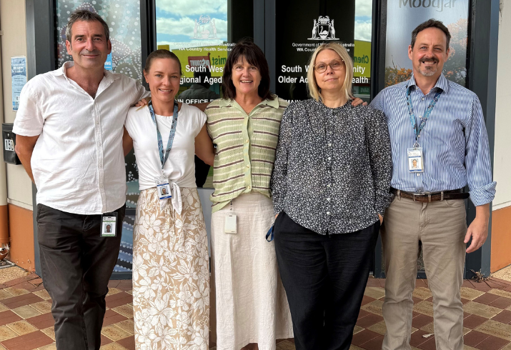 Five people from the South West Aged Care team standing in a line outside the front of the building.