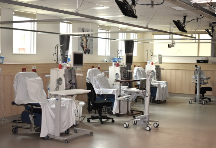 A room with three renal haemodialysis chairs and associated clinical equipment