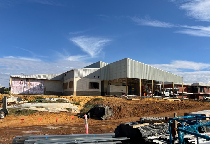 Mullewa Community Hospital under construction, a clear blue sky with a near complete building sitting atop a busy worksite.