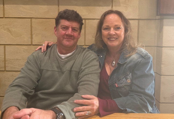 Man and woman sitting at table.