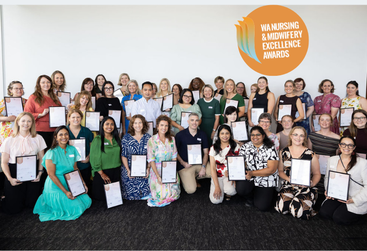A large group of people pose for the camera holding their finalist certificates in the 2026 WA Nursing and Midwifery Excellence Awards