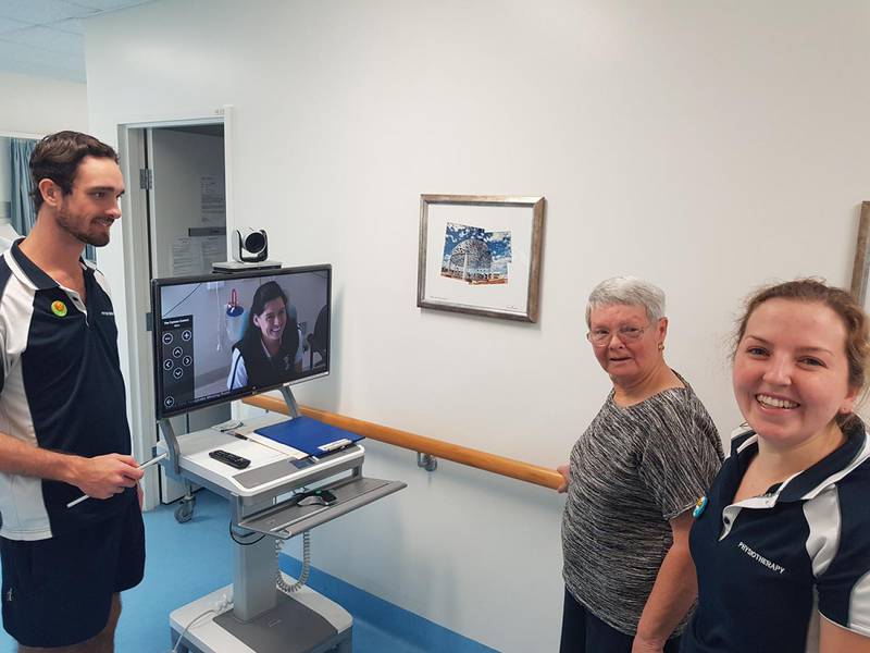 Osborne Park Hospital stroke rehabilitation unit senior physiotherapist Jessica Nolan uses telehealth to work with Geraldton Hospital physiotherapists, Elise Gollow and Joel Stephens, to guide stroke patient Janet Cozens through rehabilitation which helped her walk again.