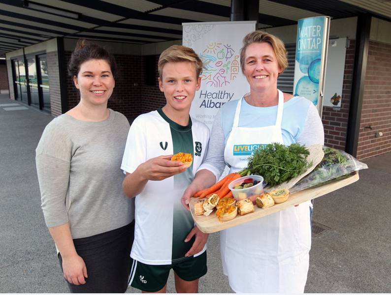 From left: Kirsten Rudolph and Charlie Walters from Port Albany football club sampling some healthy canteen snacks with WACHS Healthy Albany, Project Officer, Megan Press.