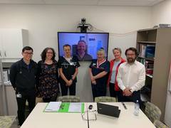 From left: Dr James Teh, Dr Amanda Villis , Dr Brian Cunningham, Dr Damien Zilm (onscreen), Emergency Nurse Practitioners Ronnie Taylor and Sonia Thurect and Dr Justin Yeung provide specialist clinical advice state-wide via telehealth technology.