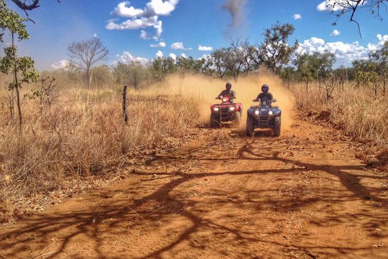 2 quad bikes on a red dirt track