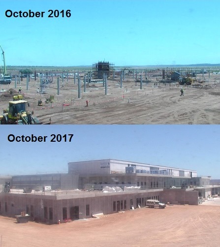 two photos taken a year apart of the same site, the first photo with only a building foundation in the ground and several columns sticking out of the ground, the second with an almost finished building.