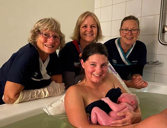 Amy with her minutes-old newborn Doug, supported by midwives (L to R) Cheryl Gordon, Melony Halsall and Narelle Lukins.