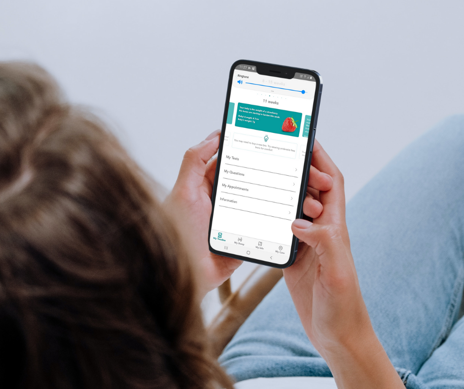 Woman locks at phone screen featuring the My Baby WA app