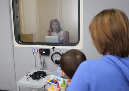 Local child Noah Osman, with mum Naoko Hira, gets an ear health check from audiologist Alison McMillan.