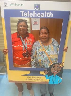 Dalphine (right) with GRAMS health worker Virginia Cameron.